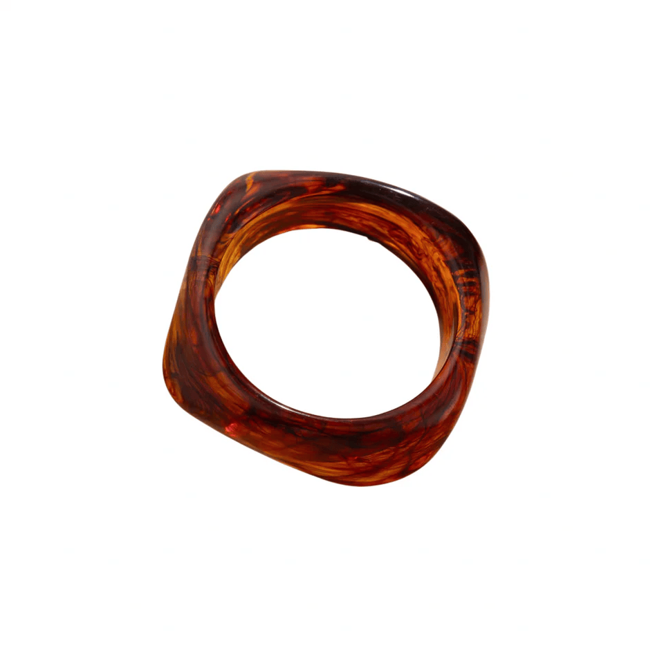 Amber acrylic bangle with tortoiseshell pattern and rounded square shape.