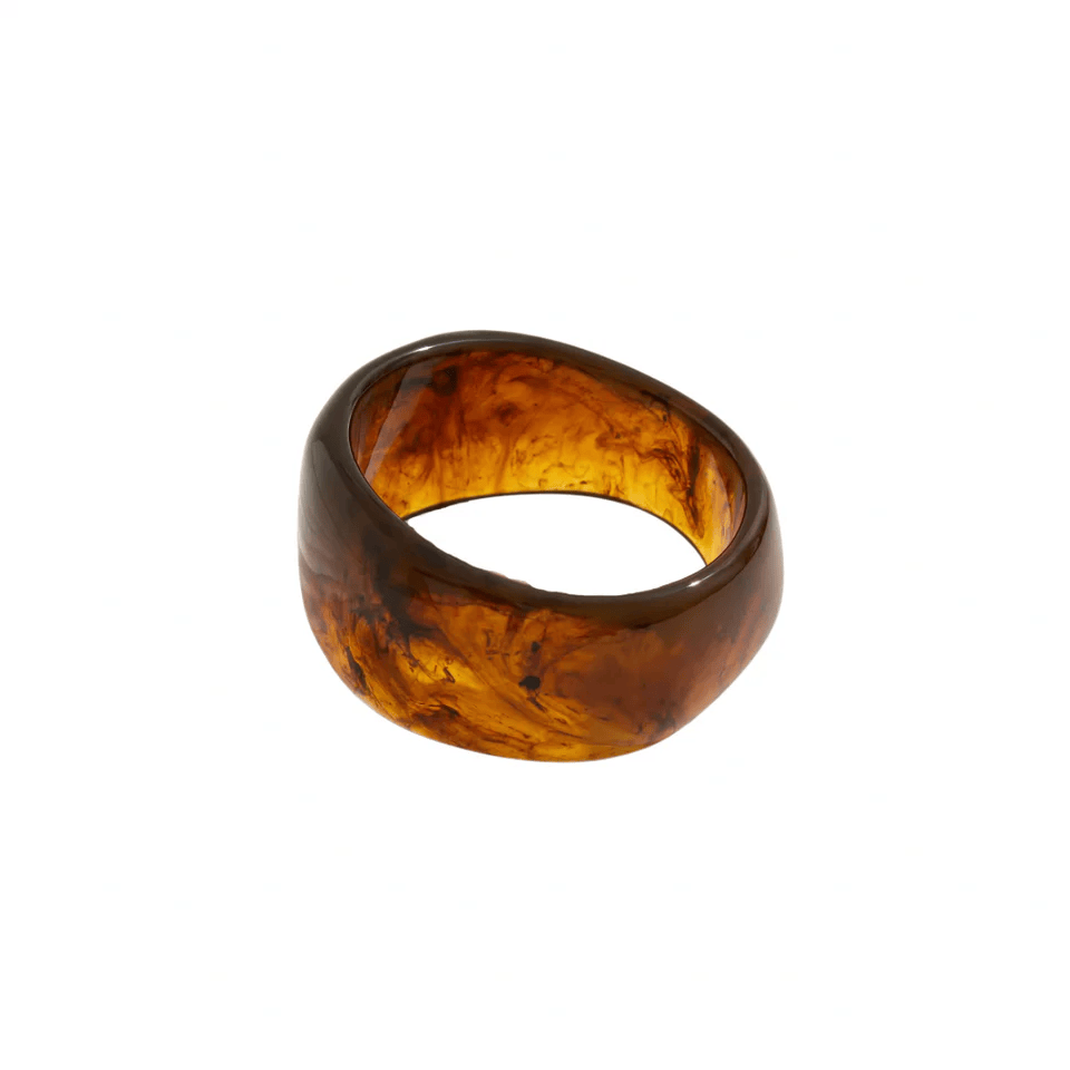 Brown acrylic bangle with translucent amber tones and dark swirled patterns throughout.