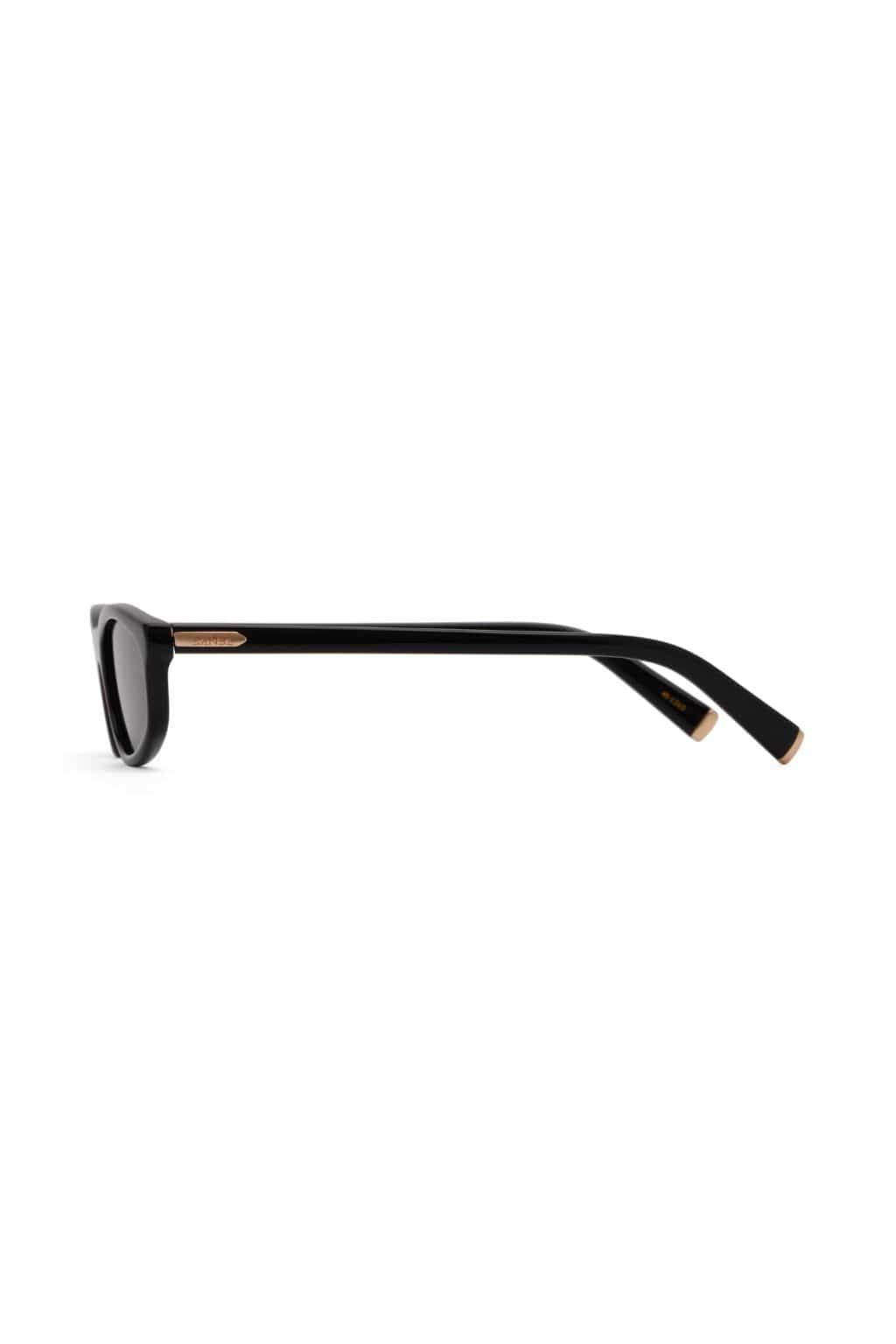 Black sunglasses with dark tinted lenses and rose gold-accented arms shown from the side view.