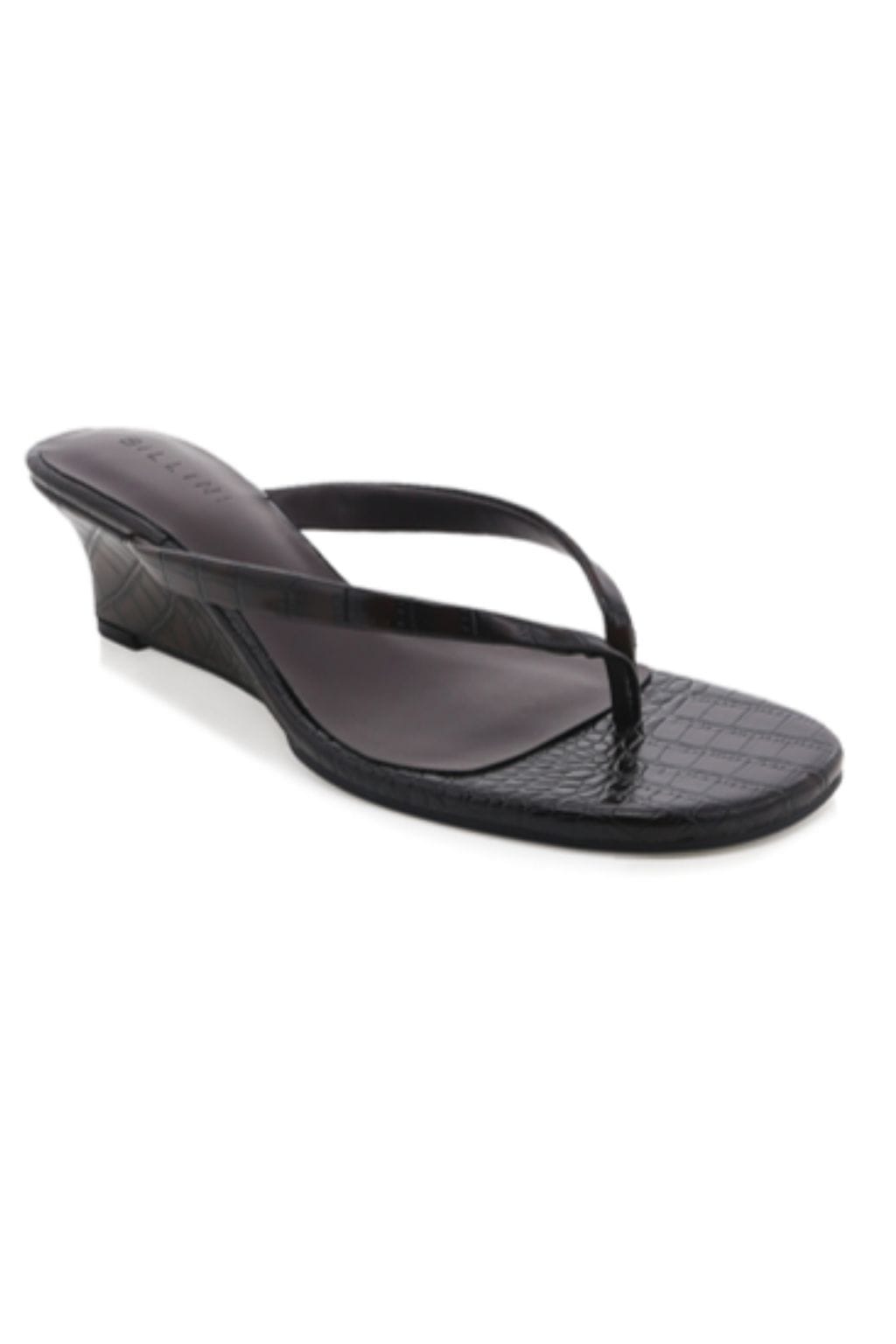 Black wedge sandal with textured footbed and thong strap.