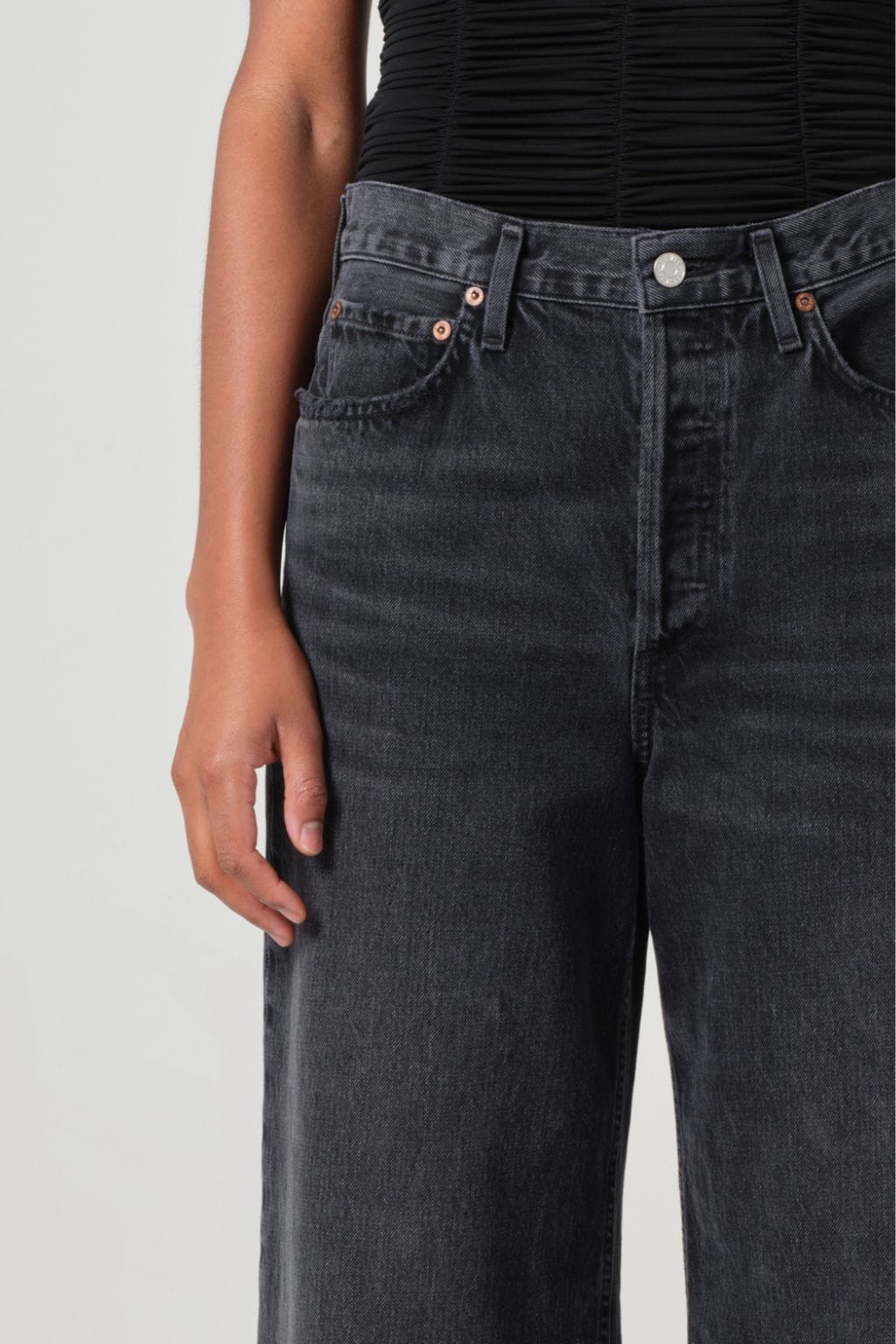 Dark indigo denim jeans with high waist, five-pocket styling, and copper-toned hardware.