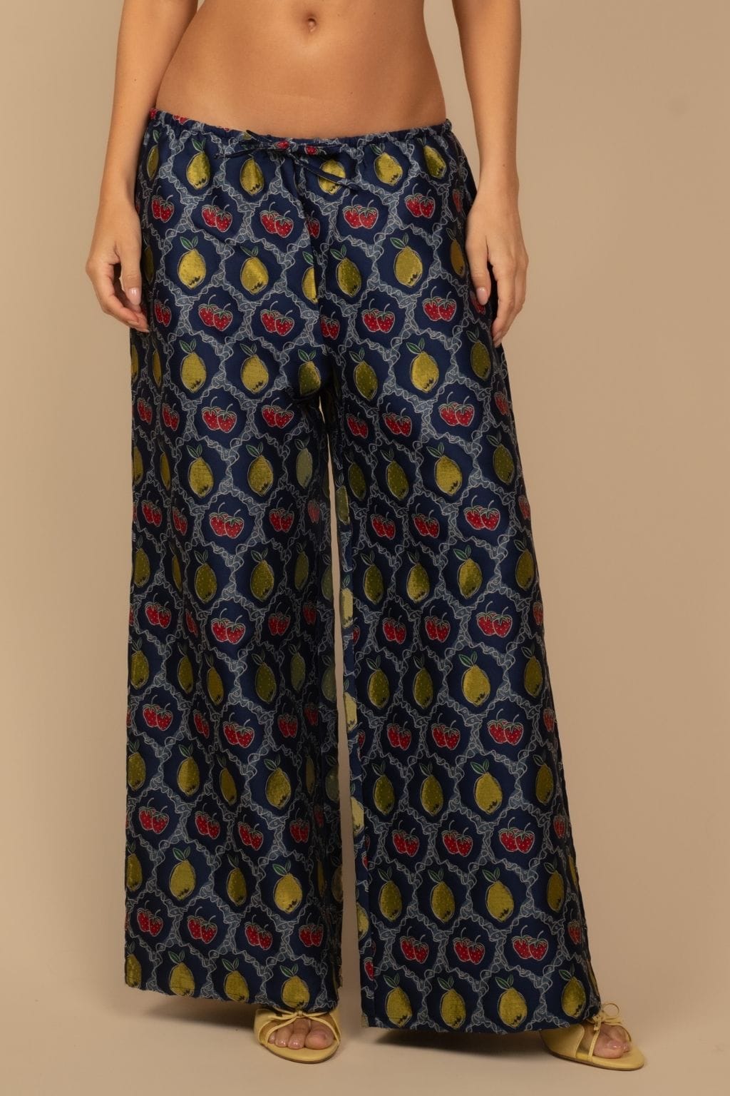 Navy wide-leg pants with yellow pears and red apples jacquard pattern and drawstring waist.