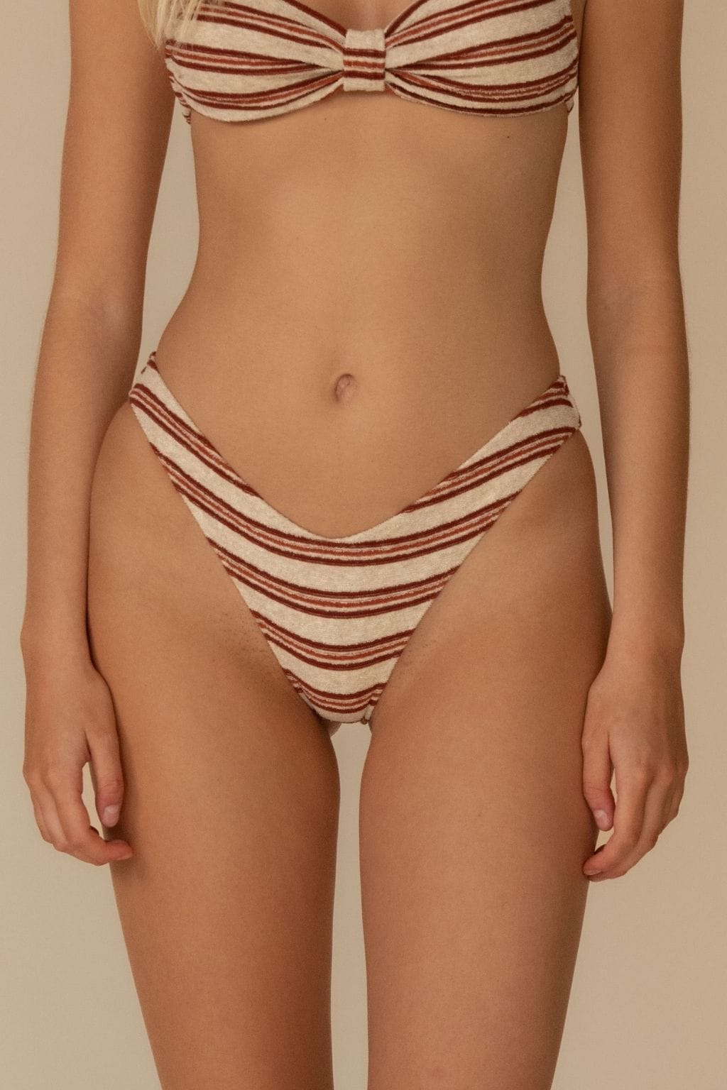 Cream and burgundy striped bikini bottom with zig-zag stitching detail and horizontal stripe pattern.