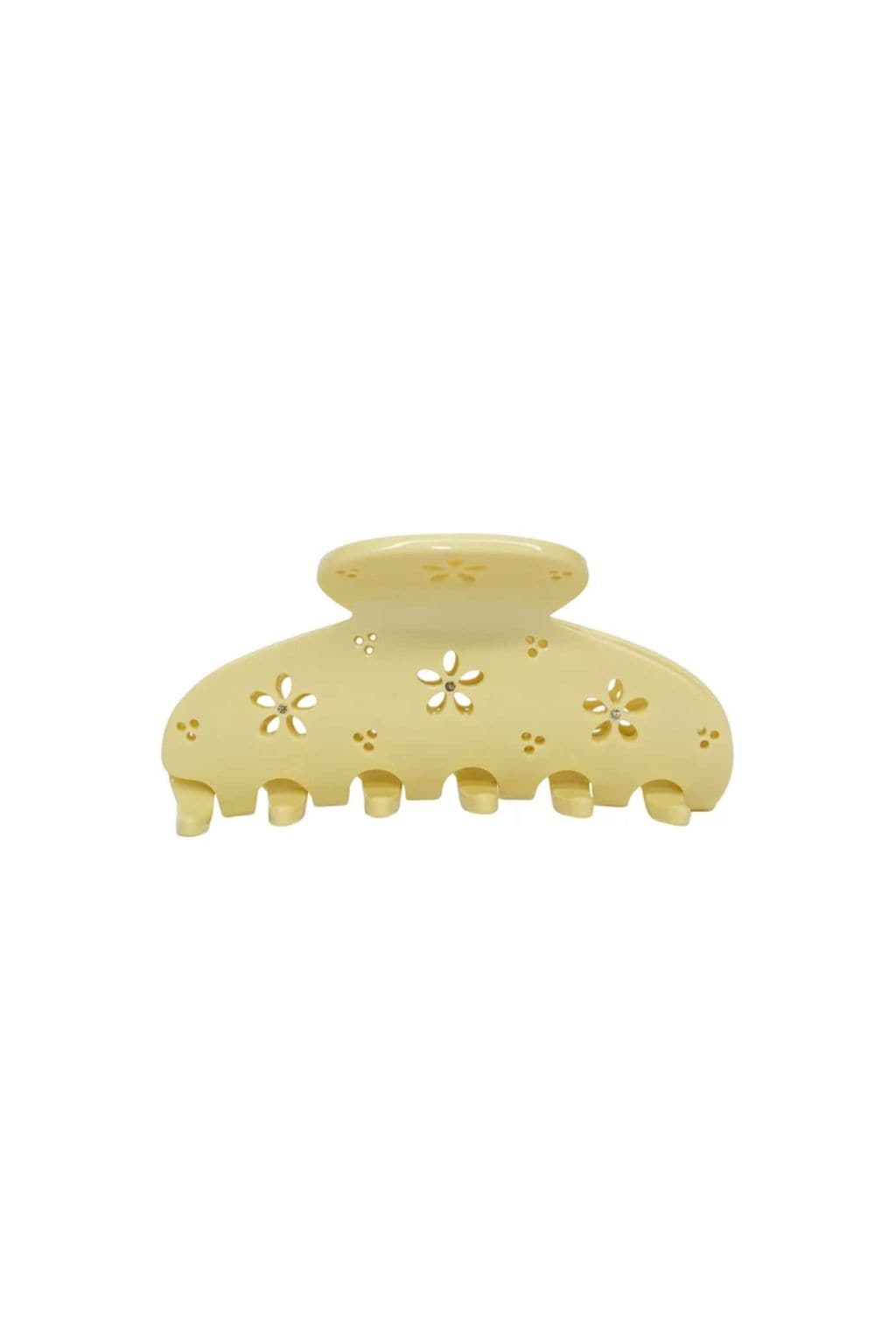 Pale yellow hair clip with floral and dot cutout details and scalloped teeth along the base.