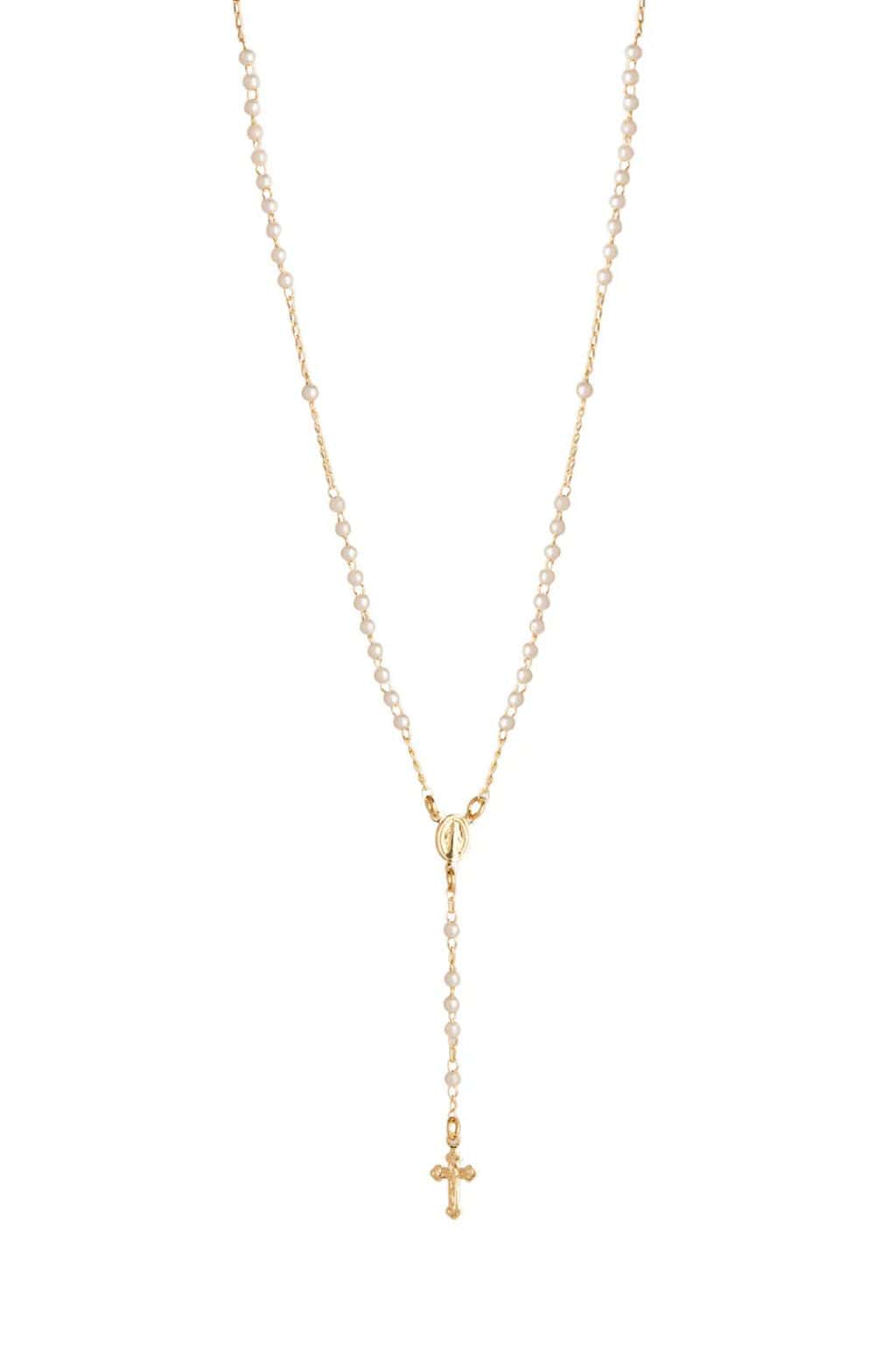 Gold-tone chain necklace with small cream pearls and a decorative cross pendant at the end.