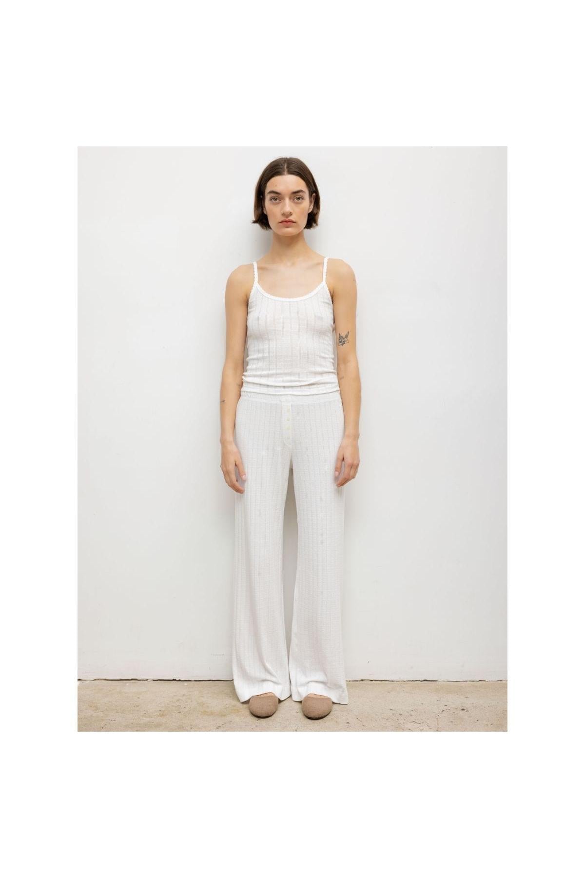 White pointelle boxer pant with textured knit pattern and wide-leg silhouette, shown on model with matching camisole.