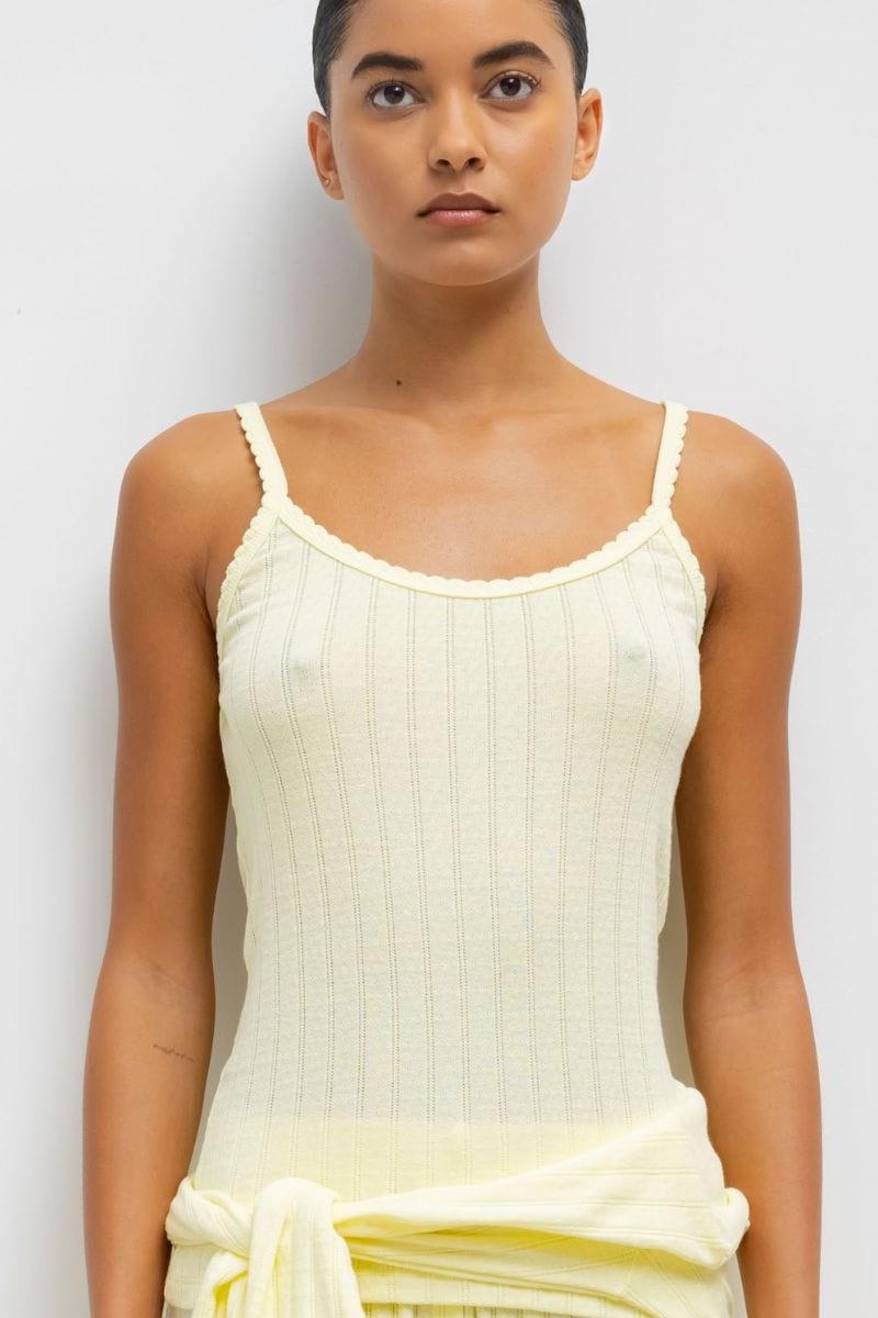 Cream pointelle tank top with thin straps and scoop neckline, displayed on model.