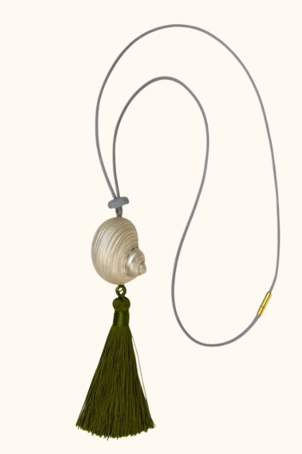 Gray cord necklace with textured cream pendant and olive green tassel.