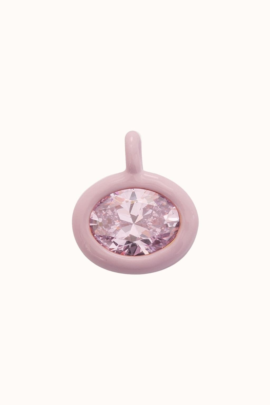 Pink tourmaline gemstone set in a rounded pink metal pendant with loop attachment.