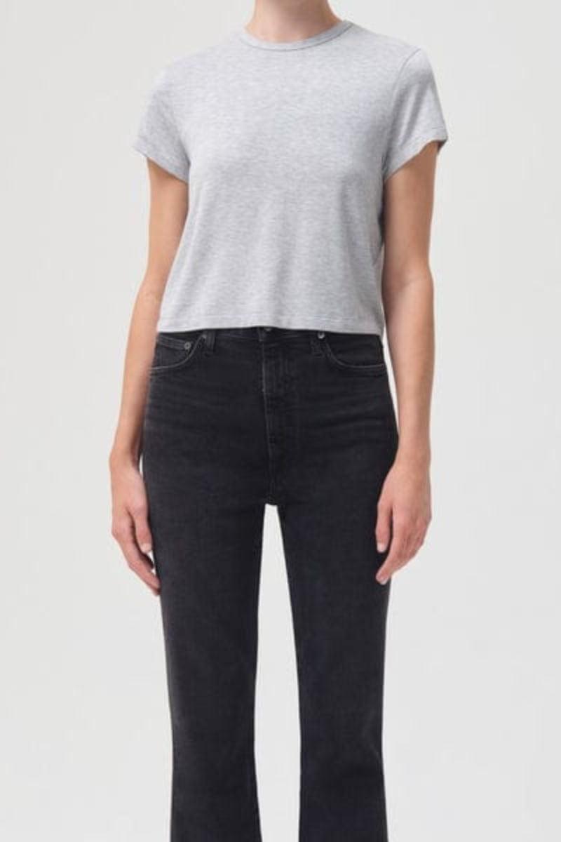 Grey heather short-sleeve crew neck tee with cropped fit styled with dark wash jeans.