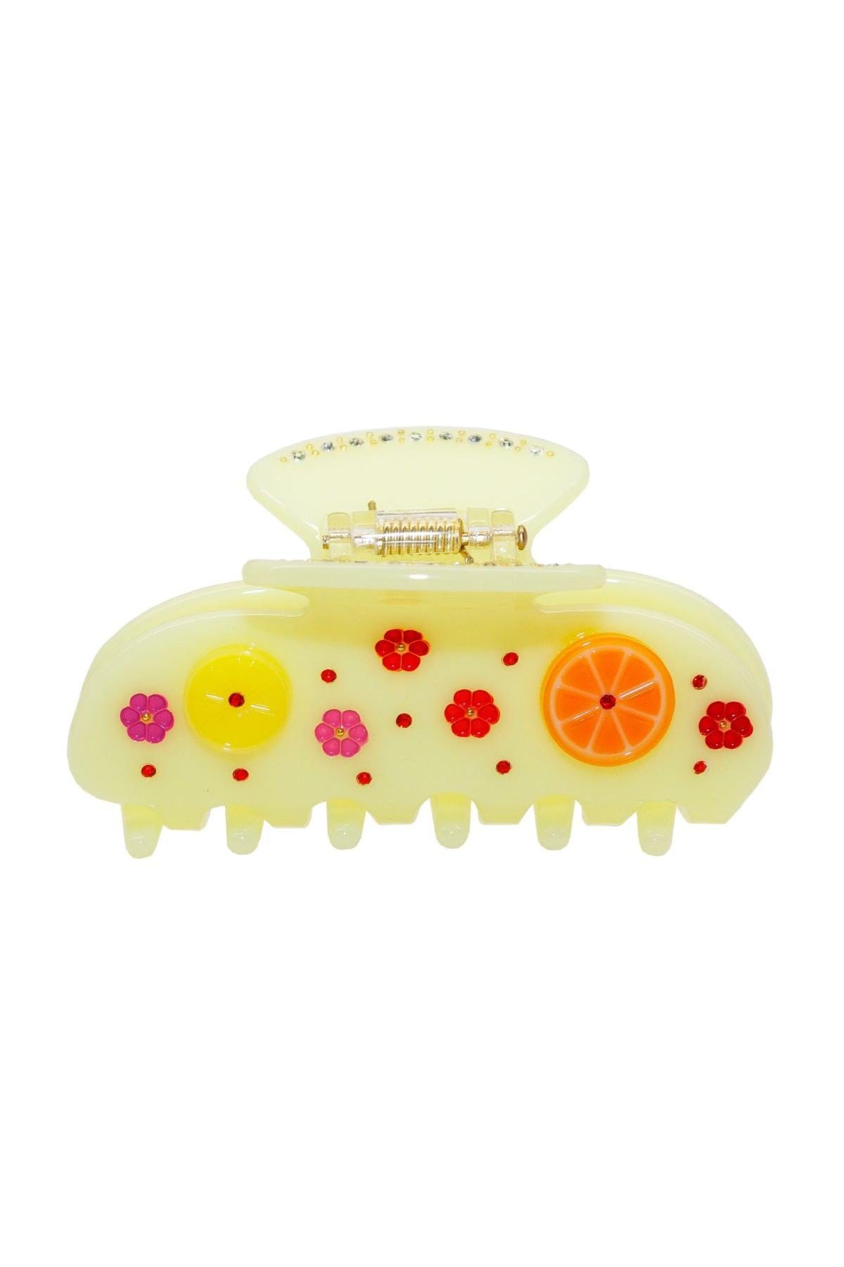 Pale yellow hair clip with gold-tone clasp decorated with colorful flowers and orange slice design.