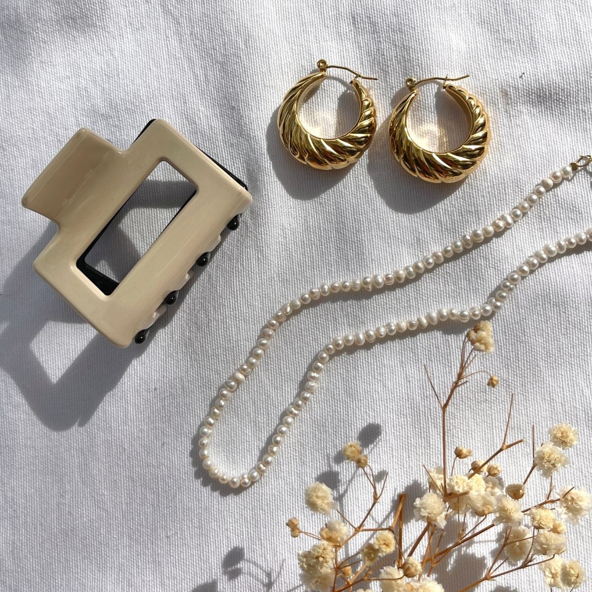 Rectangular hair clip with nude and black two-tone design and metal closure mechanism.