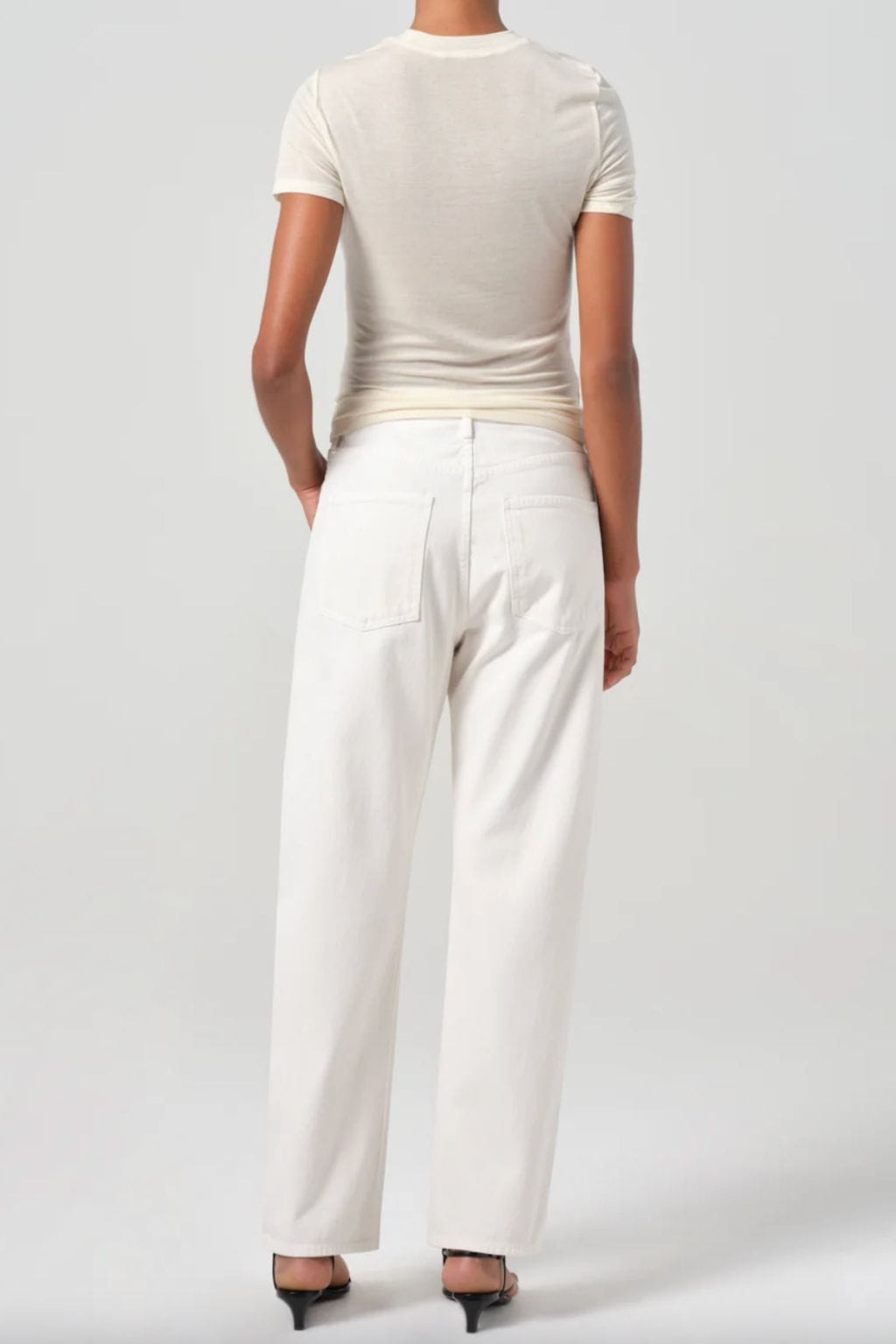 White denim jeans with high waist and straight leg fit, shown from back view with cream t-shirt.