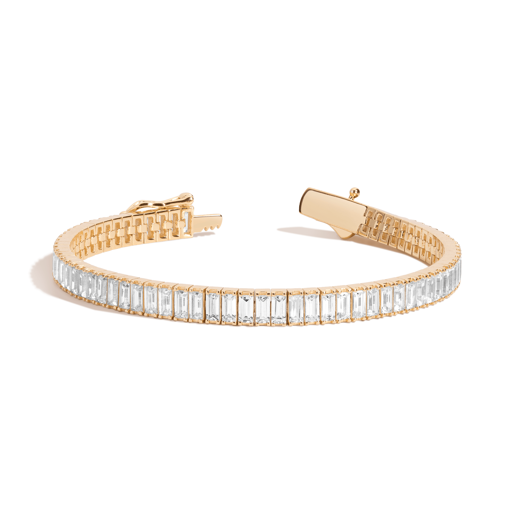 Gold-tone tennis bracelet with rectangular white stones set in a continuous row and toggle clasp.