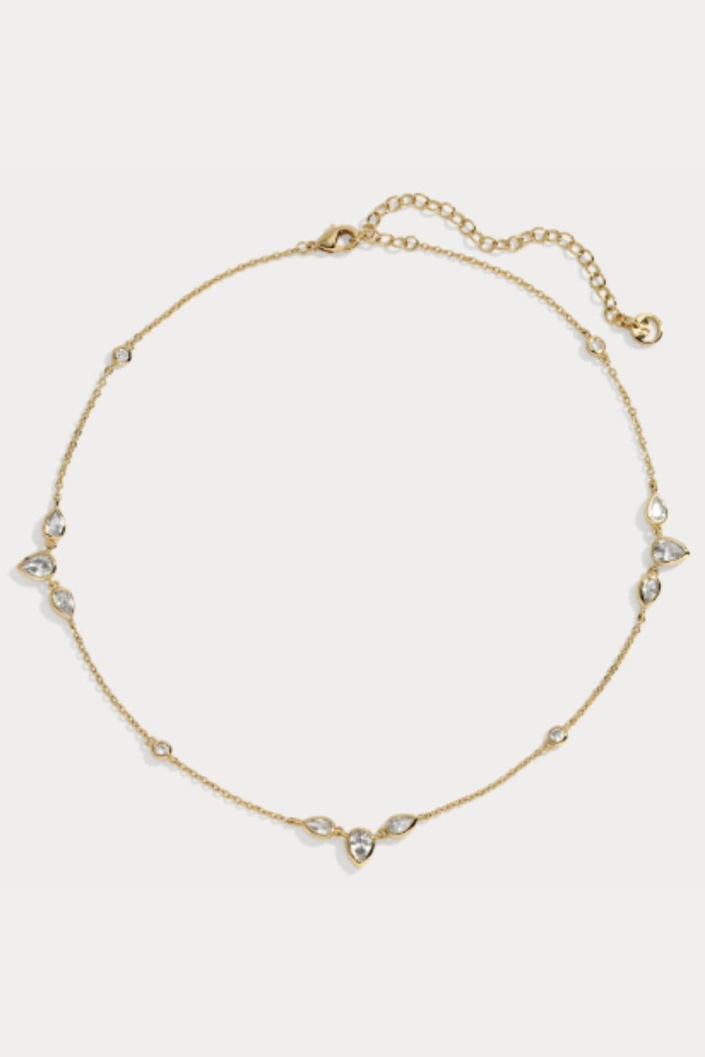 Gold-tone choker necklace with clear crystal teardrop and round stone accents and adjustable chain closure.