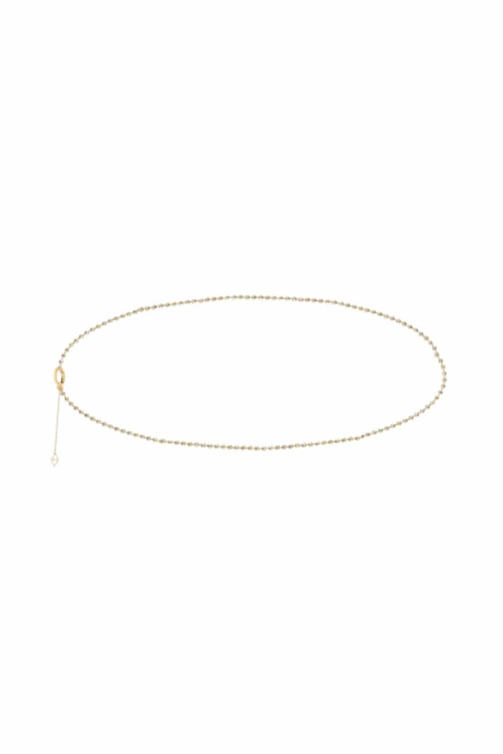 Gold-toned belly chain with small beads throughout and an adjustable clasp with dangling chain detail.