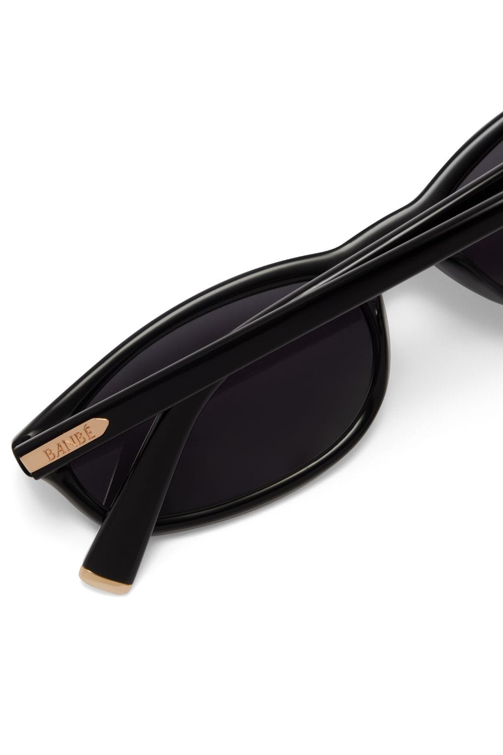 Black sunglasses with curved frame and tan-colored temple tips branded with "BAIBE" logo.