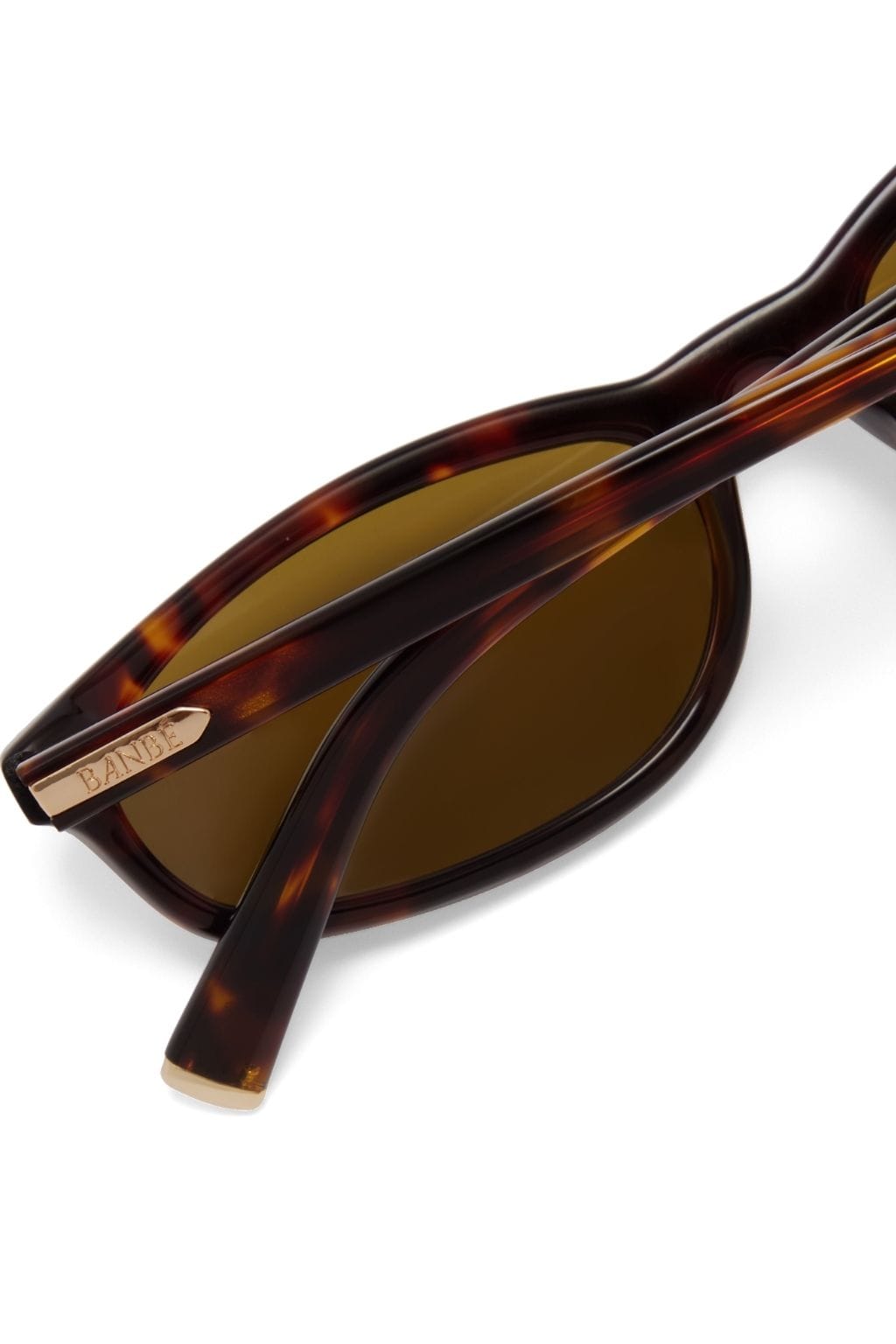 Tortoiseshell acetate sunglasses with brown lenses and metal brand detail on the temple.