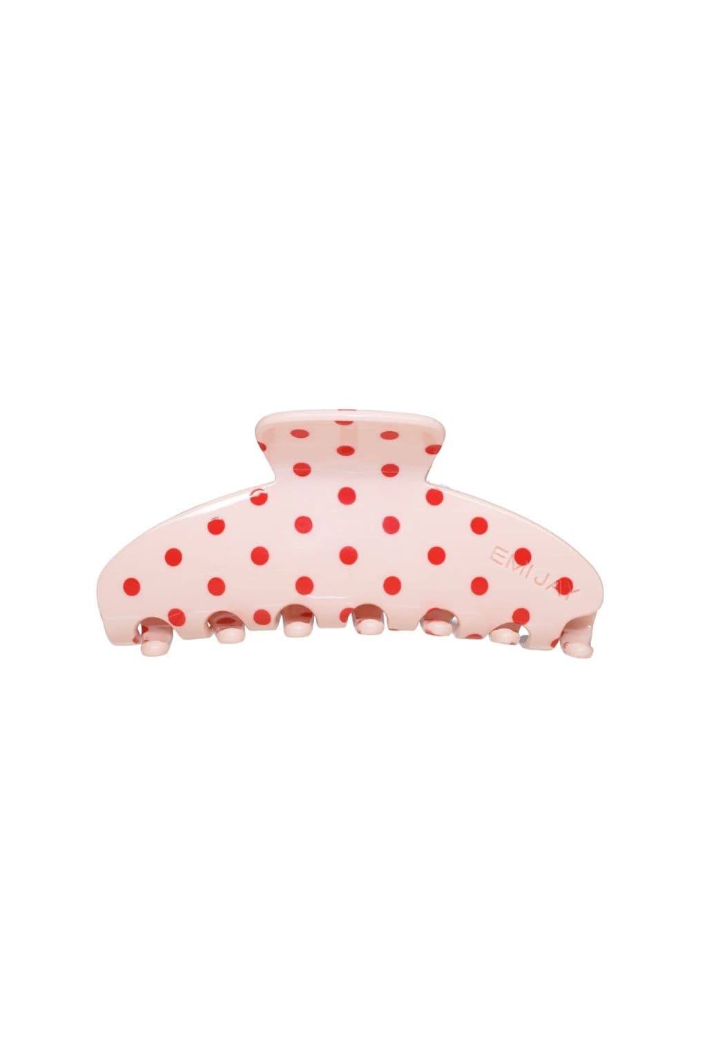 Blush-colored hair clip with red polka dots and claw grip teeth at base.