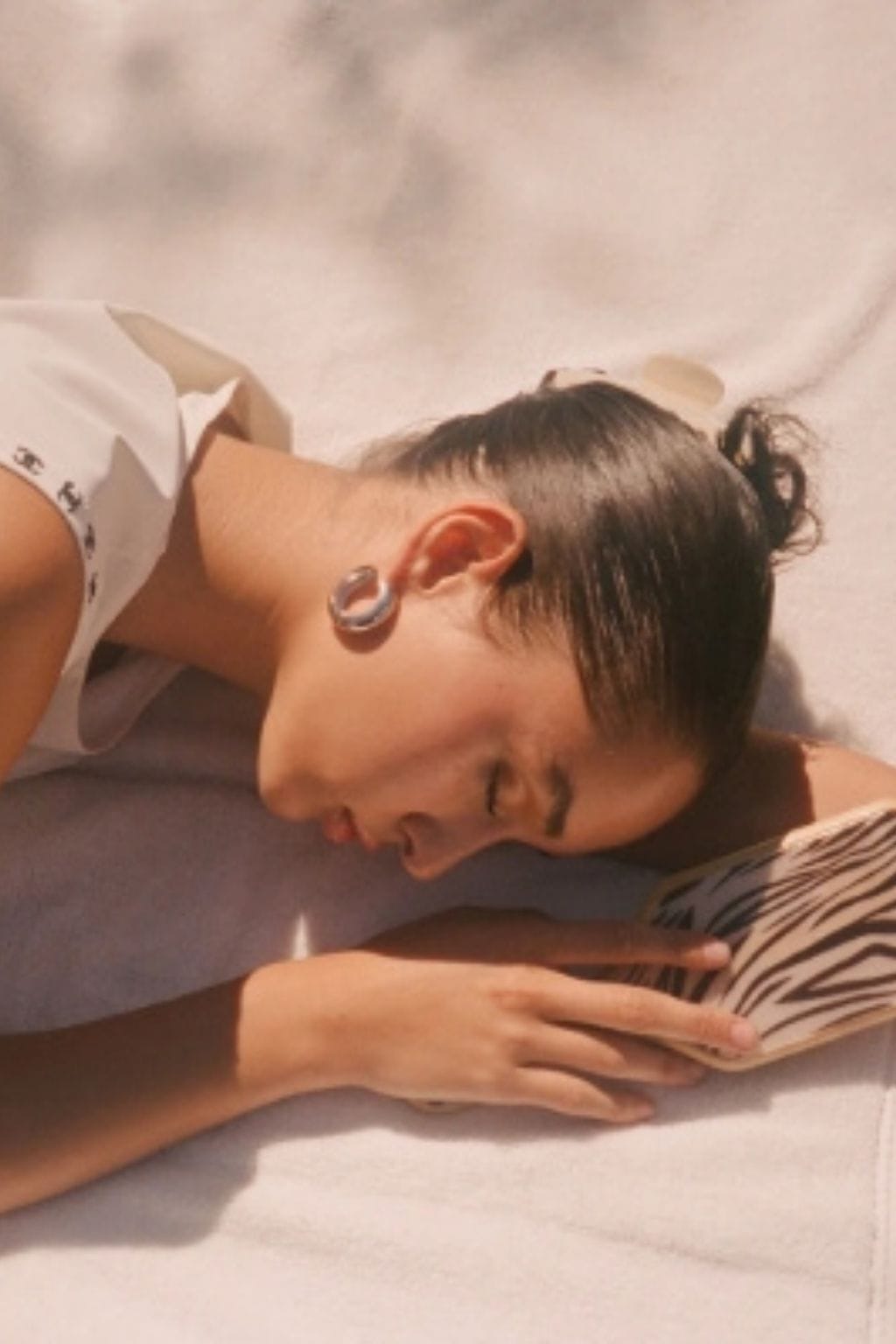 Buttercream hair clip worn by a child with dark hair styled in a bun, shown from the side.