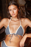 Black and white gingham bikini top with white binding and zig-zag stitched ties on model.