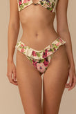 Bikini bottom with ruffled waistband in cream fabric featuring pink and red floral print.