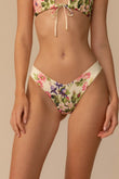 Cream bikini bottom with pink, purple, and green floral print and zig-zag stitched waistband.