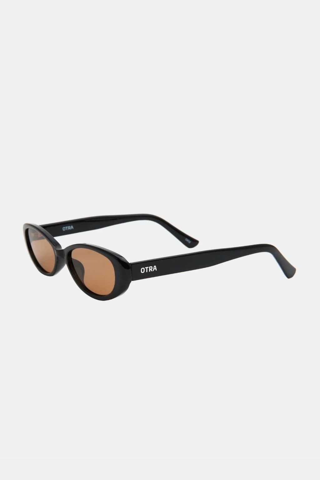 Black oval sunglasses with brown tinted lenses and OTRA branding on the arms.