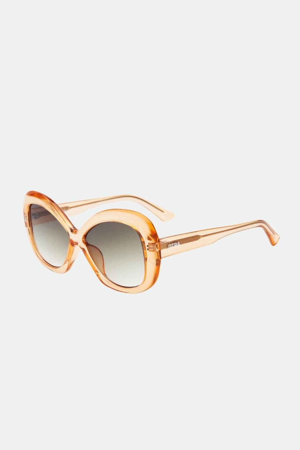 Oversized round sunglasses with transparent amber acetate frame and gradient brown lenses.
