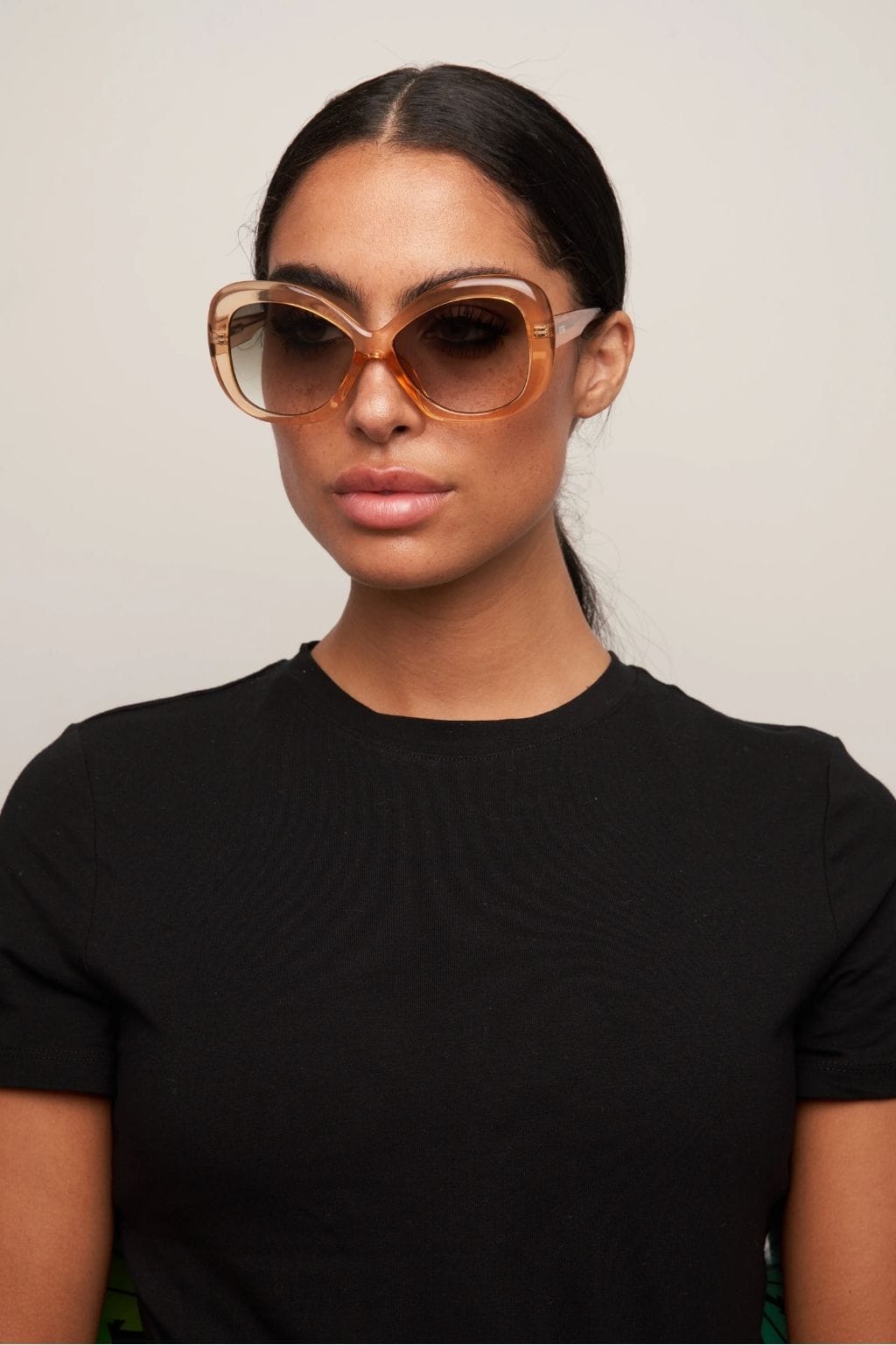 Oversized square sunglasses with translucent amber frames and gradient brown lenses.
