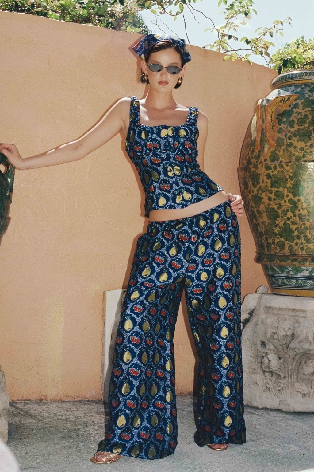 Navy wide-leg pants with multicolored fruit jacquard pattern and drawstring waist, styled as two-piece set.