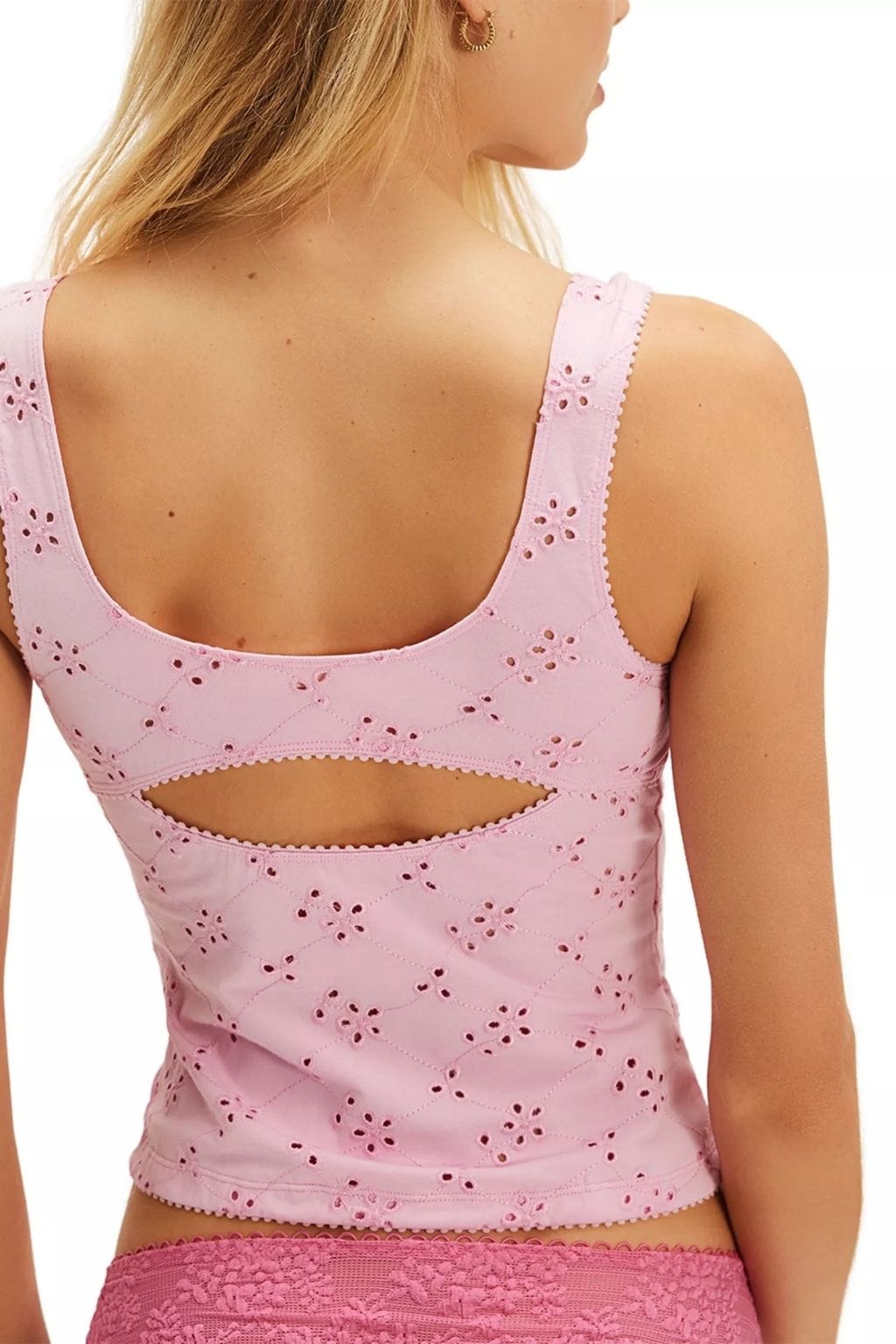 Light pink sleeveless cami with eyelet floral pattern and open cutout detail on back.