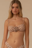 Beige lace bikini top with thin shoulder straps and a rose-shaped buckle detail at center front.