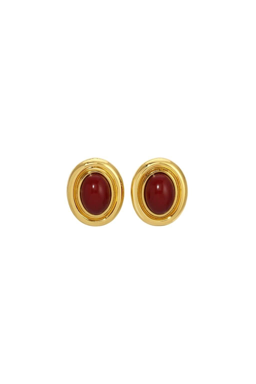 Pair of gold-toned stud earrings with burgundy oval cabochon centers and grooved bezels.