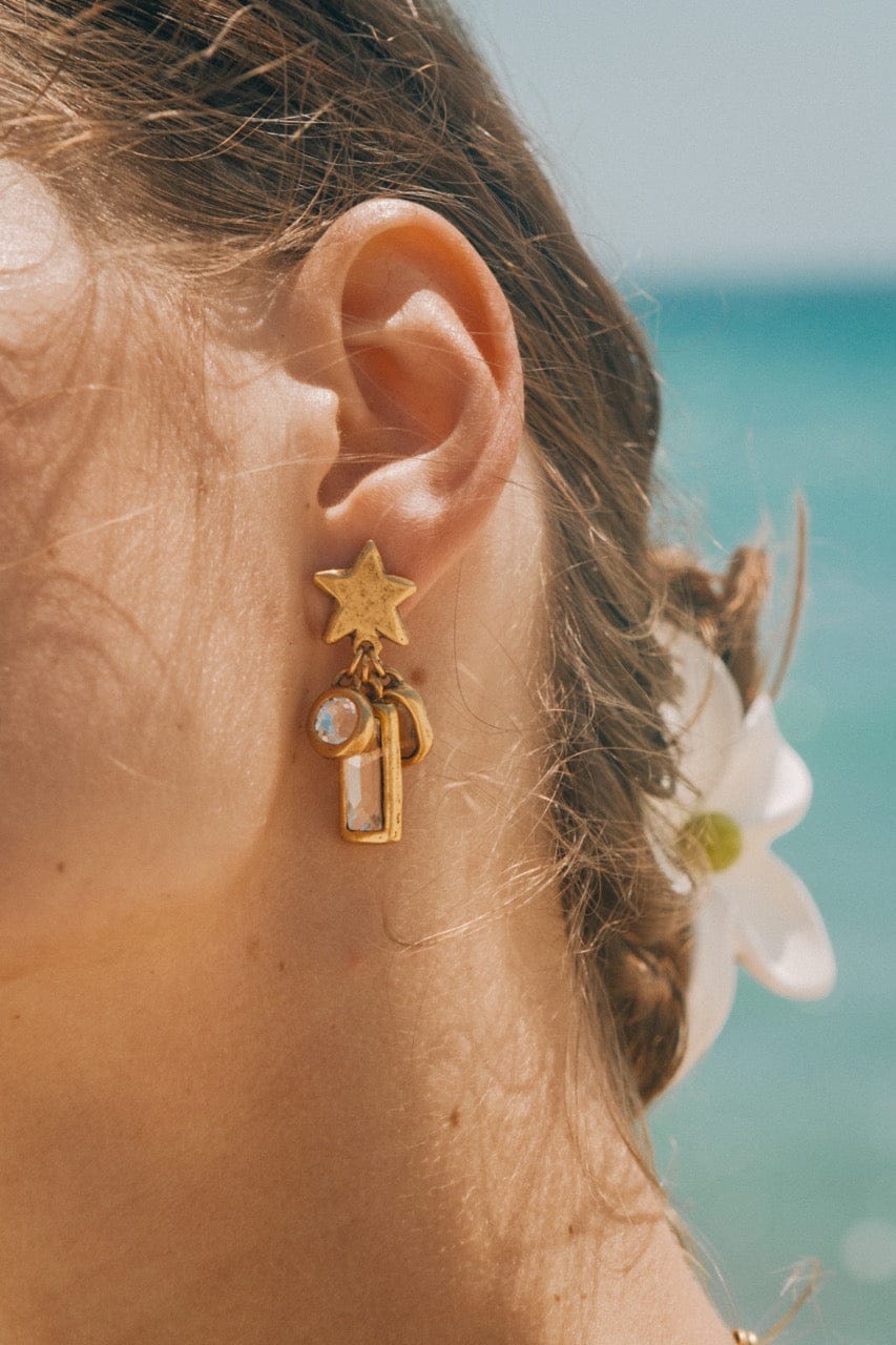 Gold drop earrings with a star stud and dangling lantern and pearl charm.