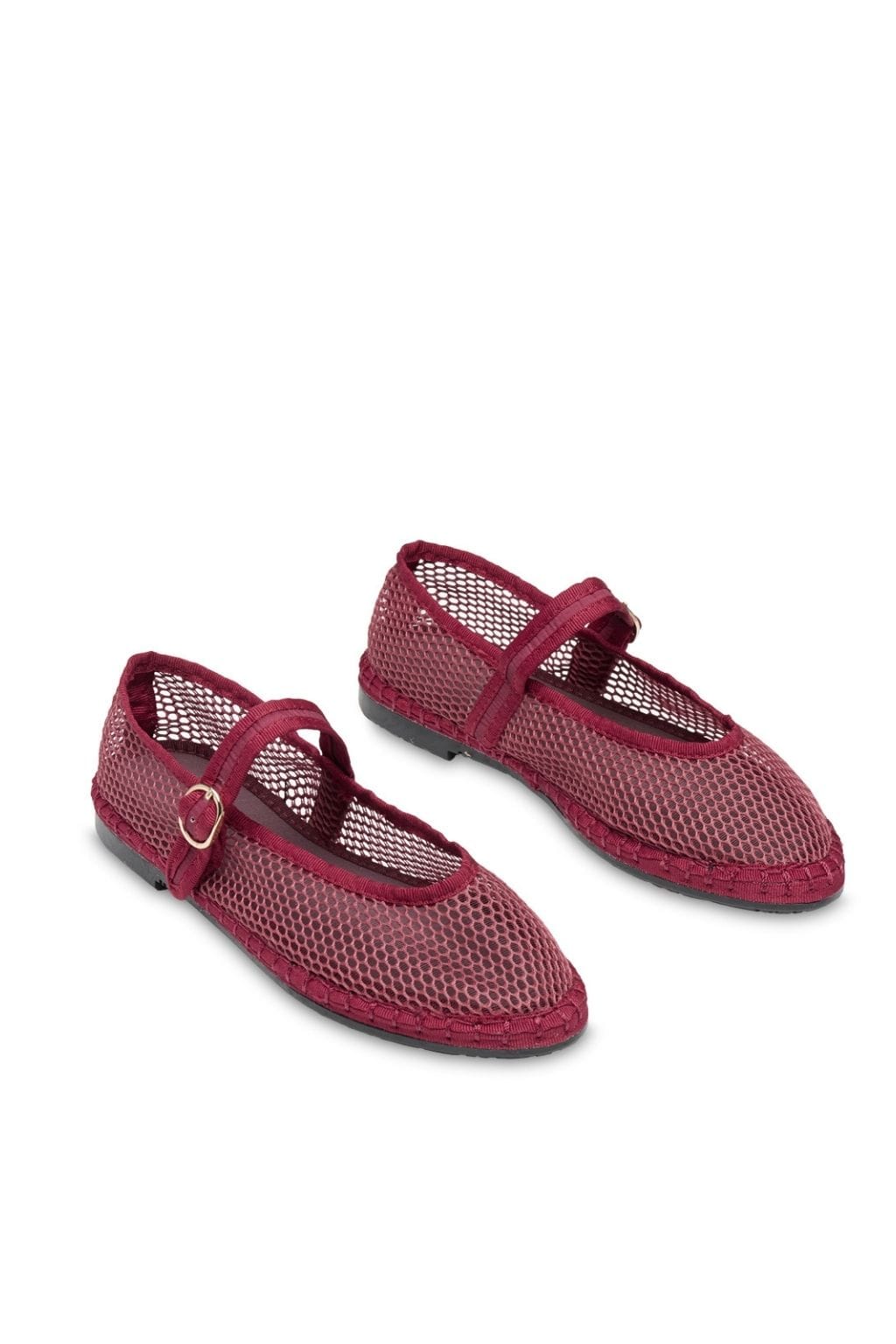 Pair of garnet mesh Mary Jane flats with buckle straps and textured rubber soles.