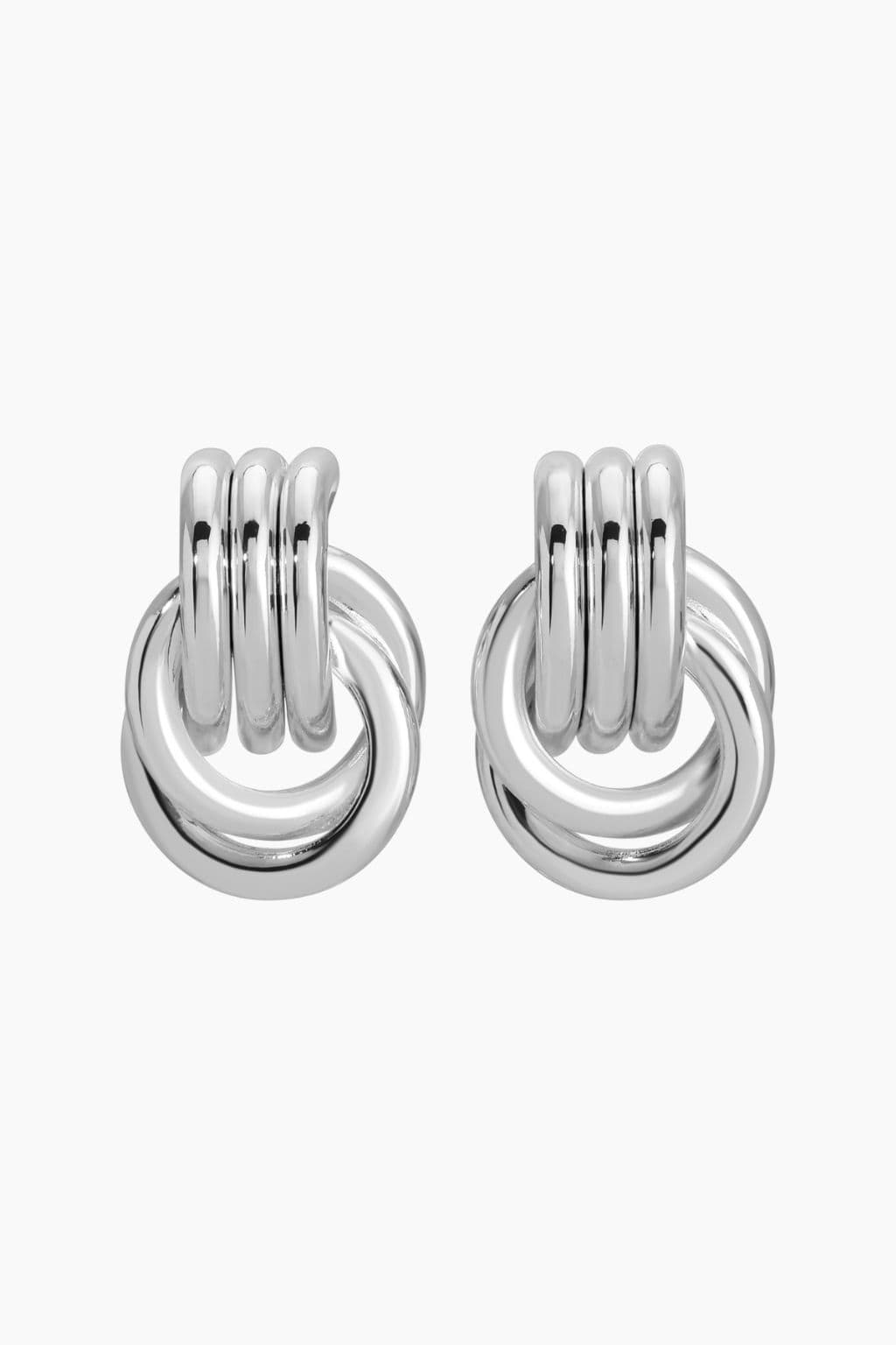 Pair of silver knot earrings with interlocking tubular and curved bands, polished finish.