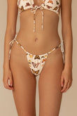Cream bikini bottom with multicolored butterfly print and side tie closures.