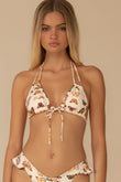 Cream bikini top with butterfly print, halter neck straps, and center tie closure.