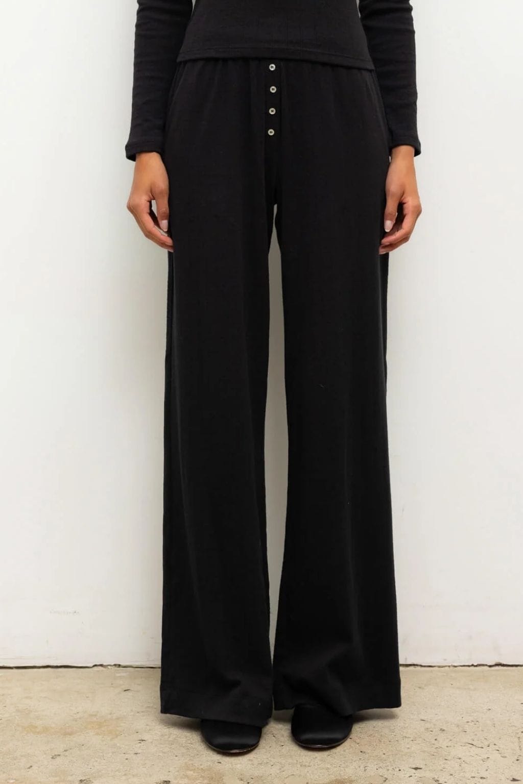 Black pointelle boxer pant with button front waistband and wide-leg silhouette.