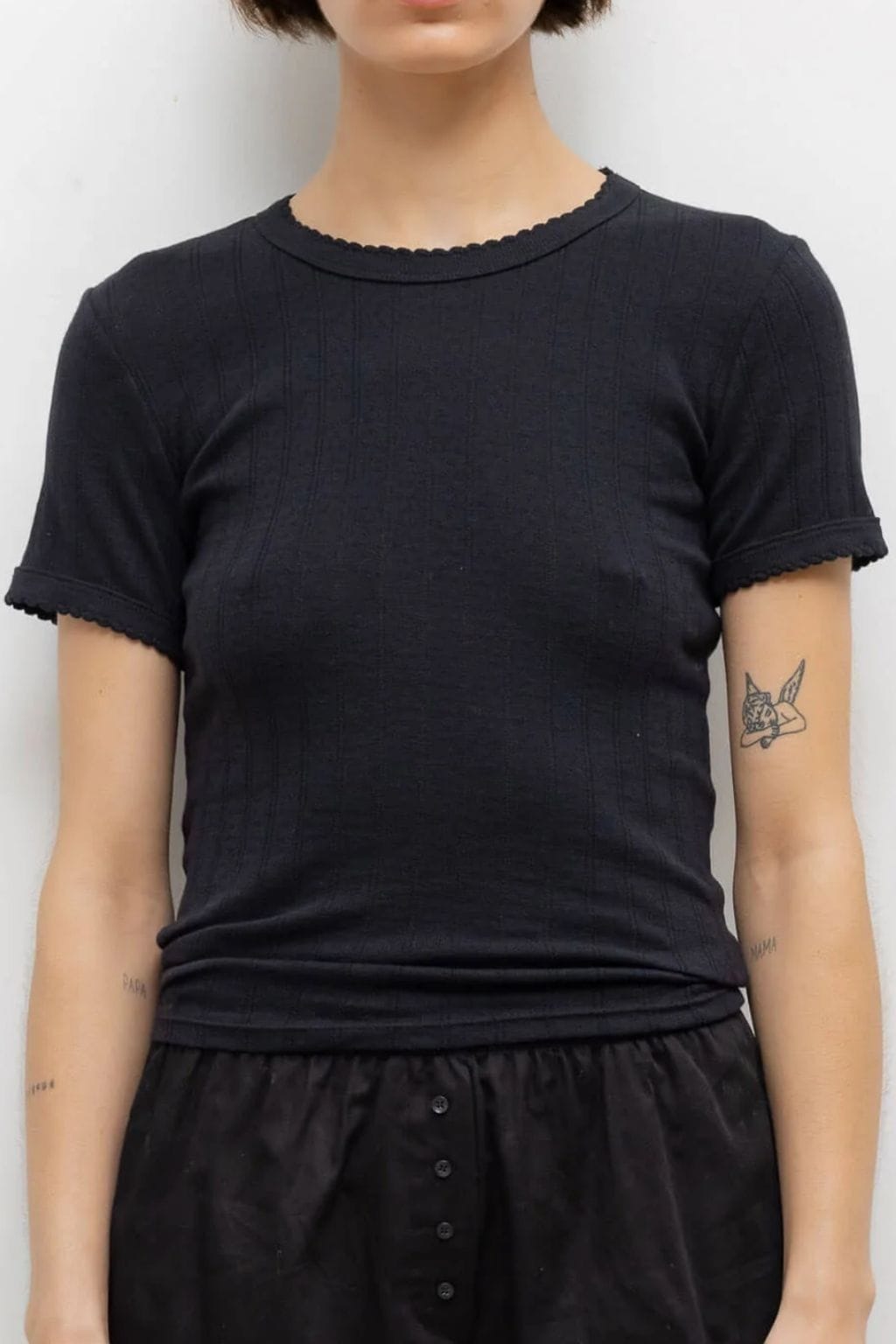 Black pointelle short-sleeve tee with scalloped neckline and cuffs on slim-fit silhouette.