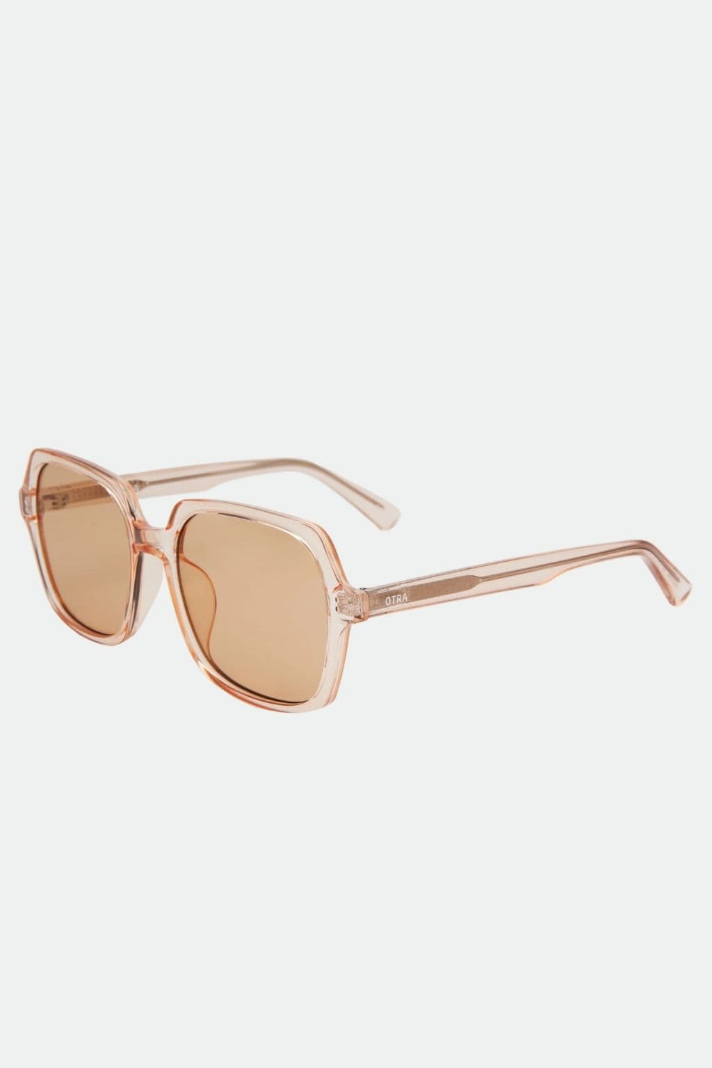 Translucent rose gold oversized square sunglasses with brown-tinted lenses and thin arms.
