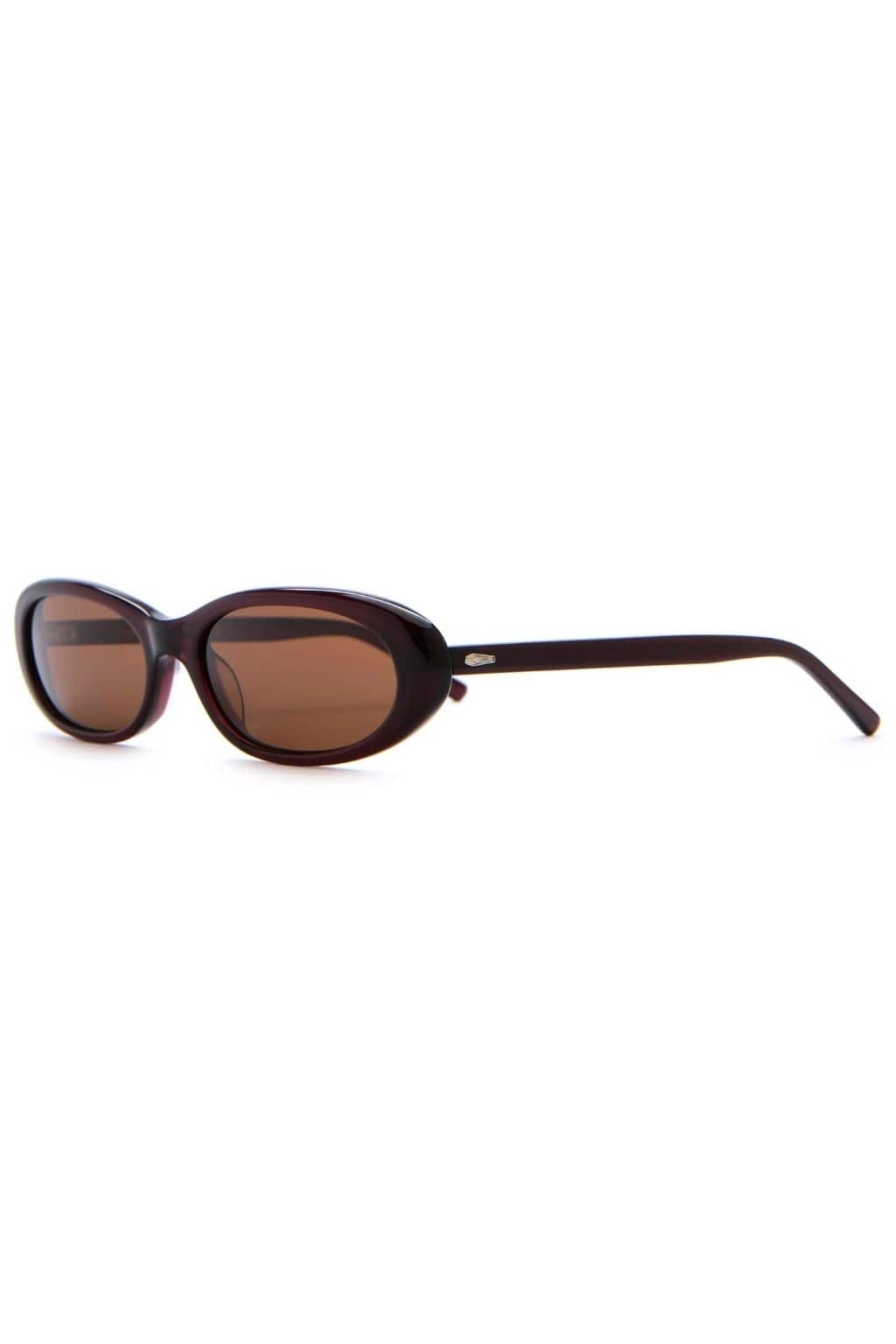 Midnight plum oval sunglasses with brown-tinted lenses and black arms.