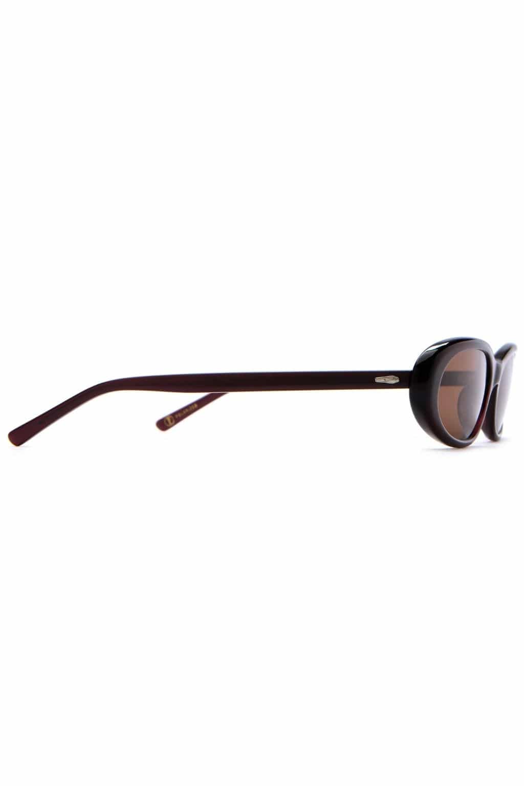 Dark plum oval sunglasses with brown tinted lenses shown from the side angle.