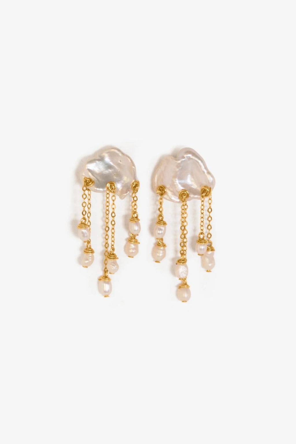 Pair of white baroque pearl drop earrings with gold-tone chains and beaded accents.