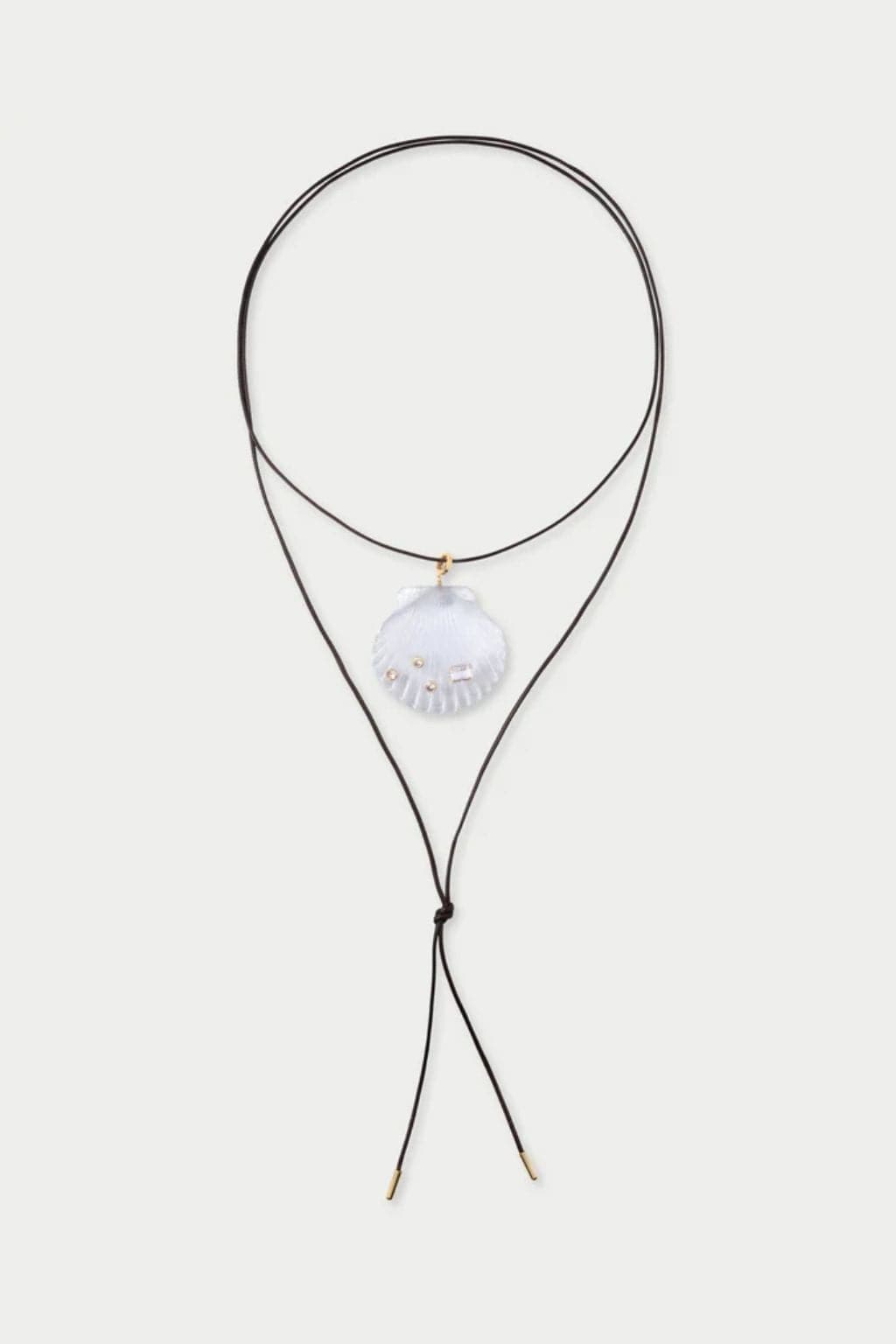 Black cord necklace with white shell pendant and gold-tone hardware.