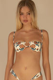 Cream bikini top with orange and teal floral print, underwire cups, and adjustable straps.