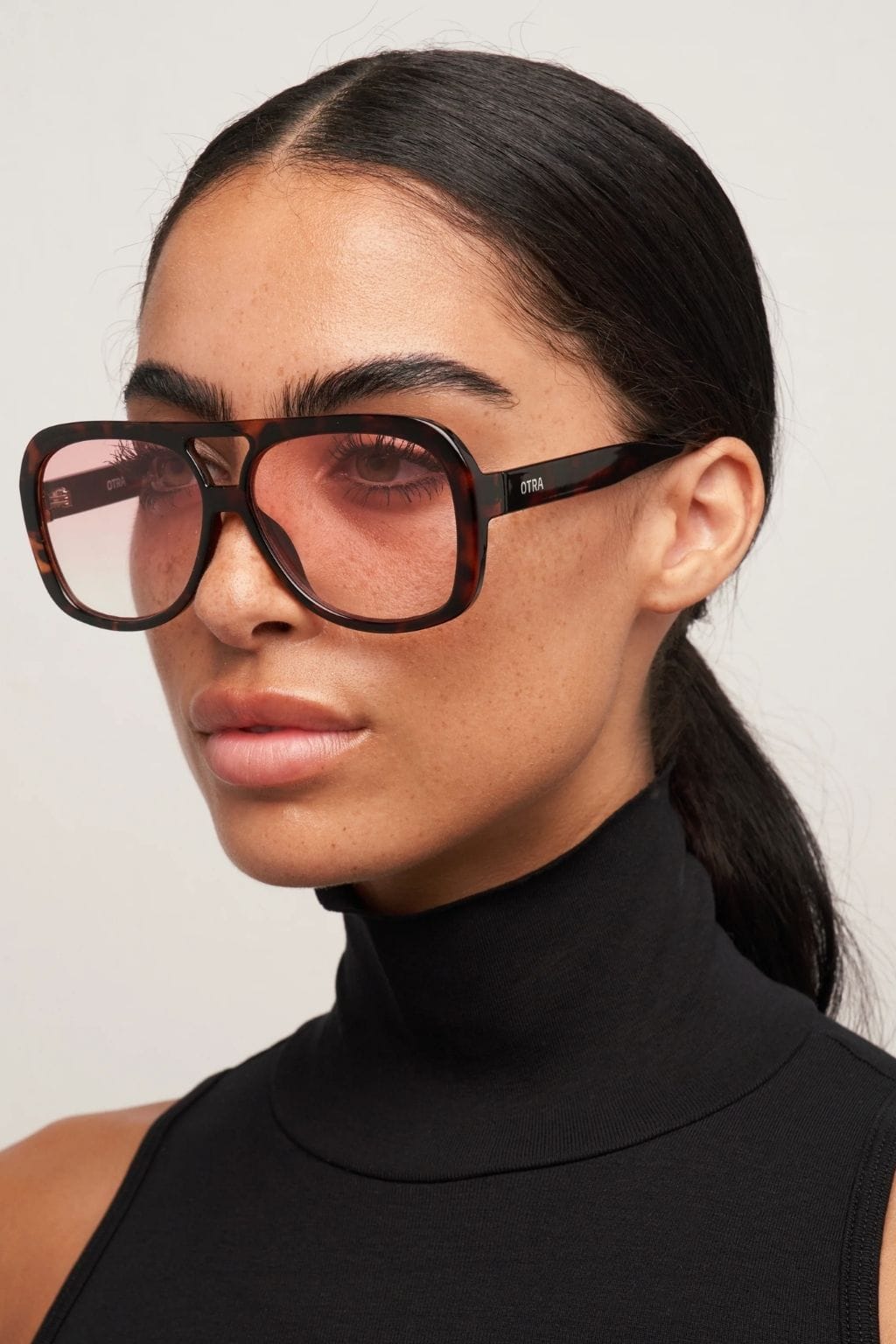 Oversized square sunglasses with tortoiseshell and pink gradient frames and tinted lenses.