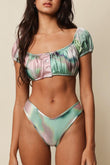 Silk dye bikini bottom with pink, green, and white watercolor pattern and contrast piping.