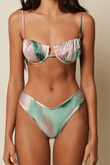 Bikini top with pink, green, and cream dye-patterned panels, thin straps, and ruffled edges.